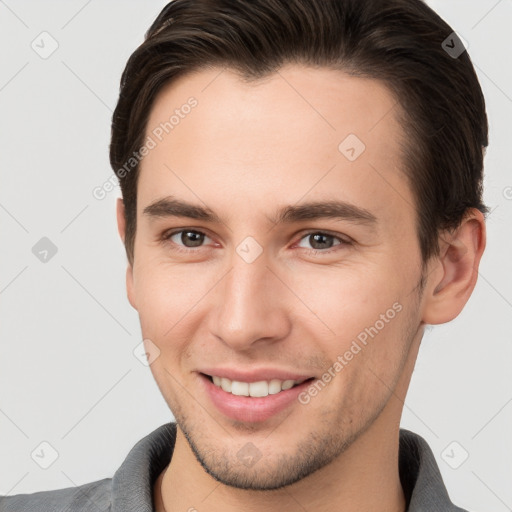 Joyful white young-adult male with short  brown hair and brown eyes