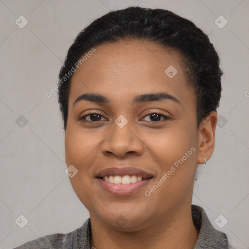 Joyful latino young-adult female with short  black hair and brown eyes