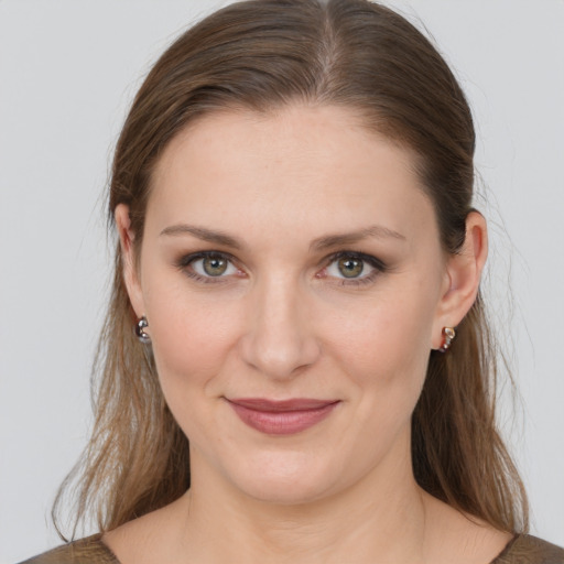 Joyful white young-adult female with medium  brown hair and grey eyes