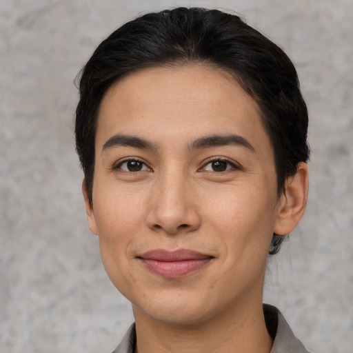 Joyful latino young-adult female with short  brown hair and brown eyes