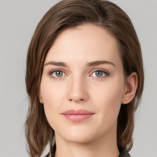 Joyful white young-adult female with medium  brown hair and green eyes