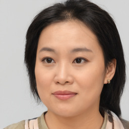 Joyful asian young-adult female with medium  brown hair and brown eyes