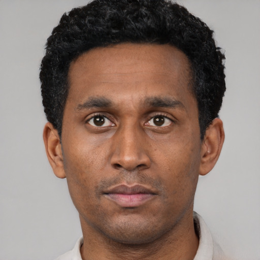 Neutral latino adult male with short  black hair and brown eyes