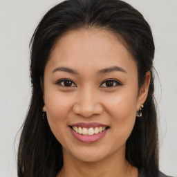 Joyful asian young-adult female with long  brown hair and brown eyes