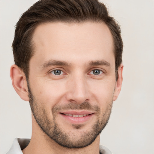 Joyful white young-adult male with short  brown hair and brown eyes