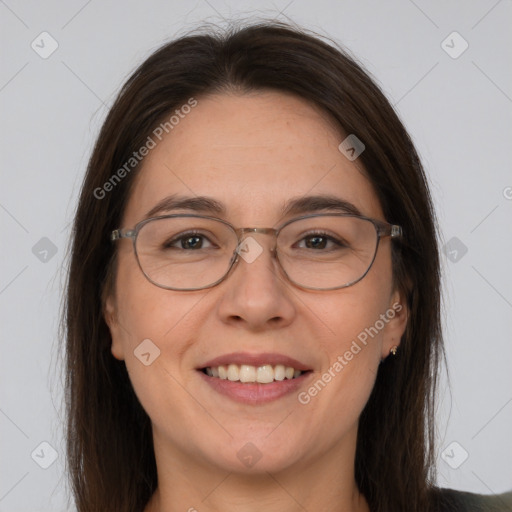 Joyful white adult female with long  brown hair and brown eyes