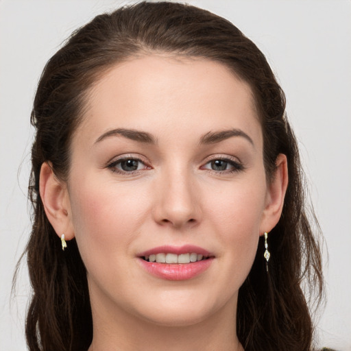 Joyful white young-adult female with long  brown hair and grey eyes