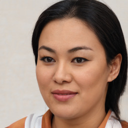 Joyful asian young-adult female with medium  brown hair and brown eyes