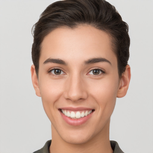 Joyful white young-adult female with short  brown hair and brown eyes