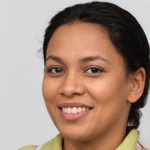 Joyful latino young-adult female with medium  brown hair and brown eyes