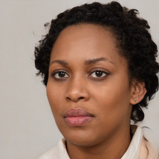 Neutral black young-adult female with medium  brown hair and brown eyes