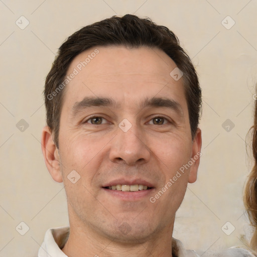 Joyful white adult male with short  brown hair and brown eyes