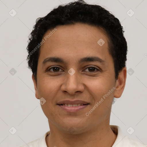 Joyful latino young-adult male with short  brown hair and brown eyes