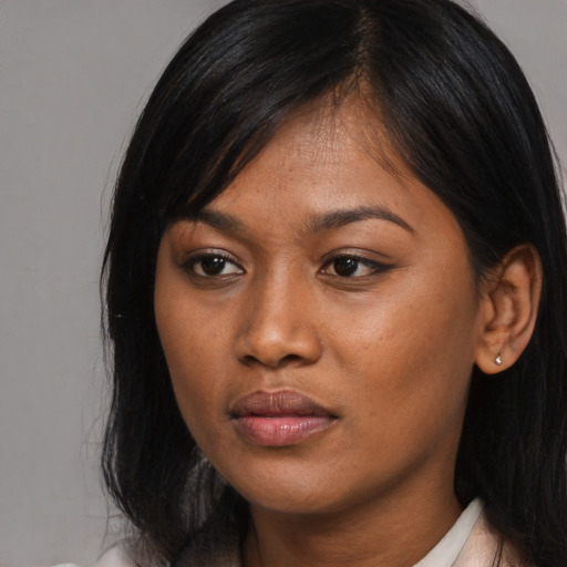 Joyful asian young-adult female with medium  black hair and brown eyes
