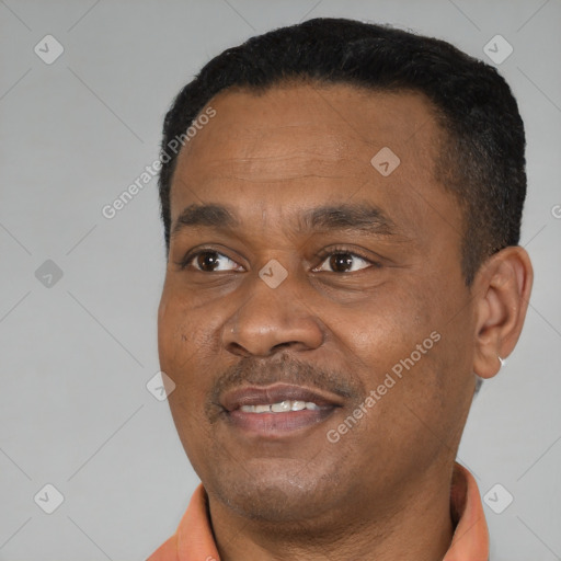 Joyful black young-adult male with short  black hair and brown eyes