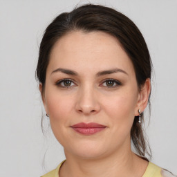 Joyful white young-adult female with medium  brown hair and brown eyes