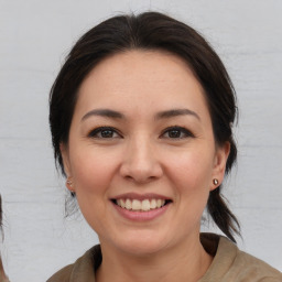 Joyful white young-adult female with medium  brown hair and brown eyes