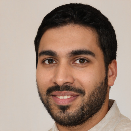 Joyful latino young-adult male with short  black hair and brown eyes