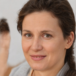 Joyful white adult female with short  brown hair and brown eyes