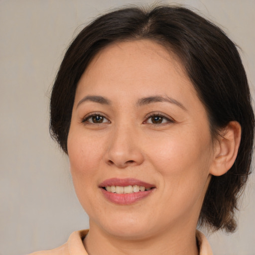 Joyful white adult female with medium  brown hair and brown eyes