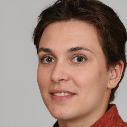 Joyful white young-adult female with medium  brown hair and green eyes