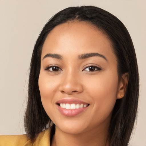 Joyful latino young-adult female with long  brown hair and brown eyes