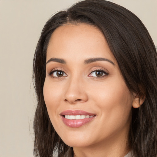 Joyful white young-adult female with long  brown hair and brown eyes