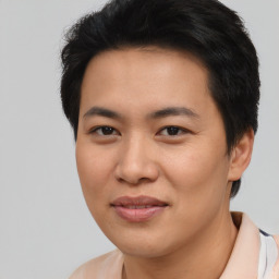 Joyful asian young-adult male with short  black hair and brown eyes