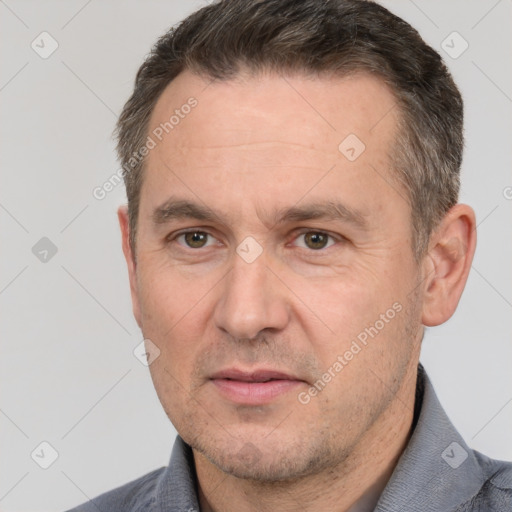 Joyful white adult male with short  brown hair and brown eyes