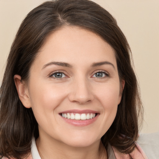 Joyful white young-adult female with medium  brown hair and brown eyes