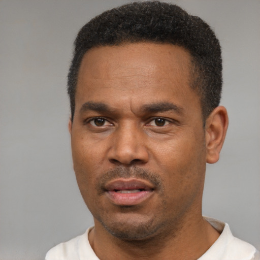 Neutral latino adult male with short  black hair and brown eyes