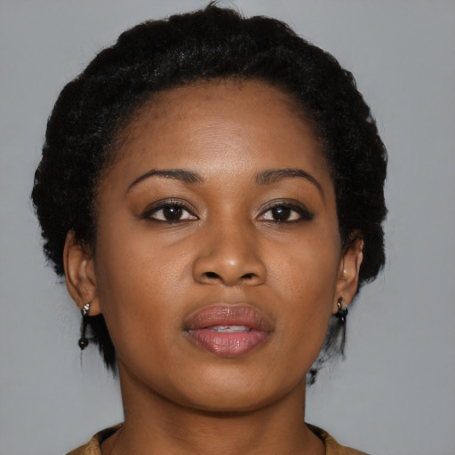 Joyful black young-adult female with medium  brown hair and brown eyes