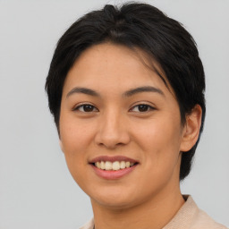 Joyful asian young-adult female with short  brown hair and brown eyes