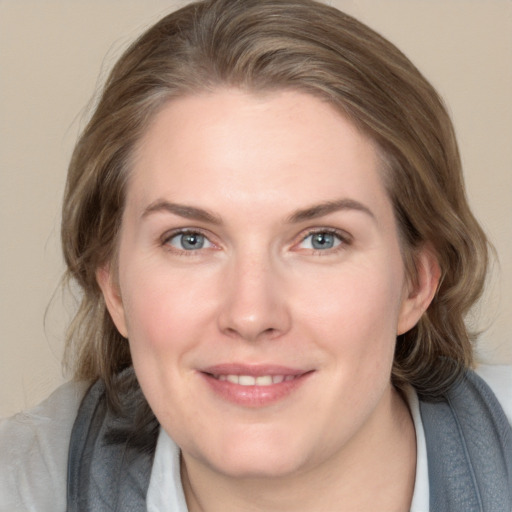 Joyful white young-adult female with medium  brown hair and blue eyes