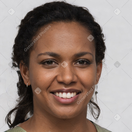 Joyful black young-adult female with short  brown hair and brown eyes