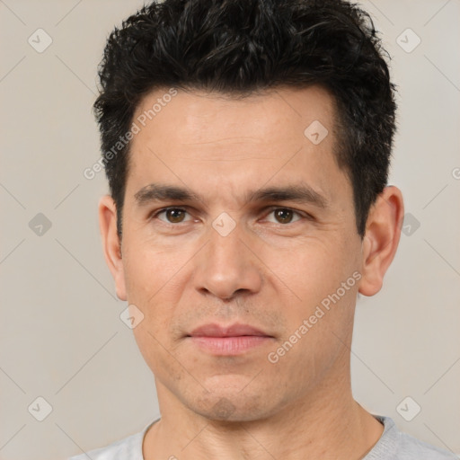 Joyful white adult male with short  black hair and brown eyes