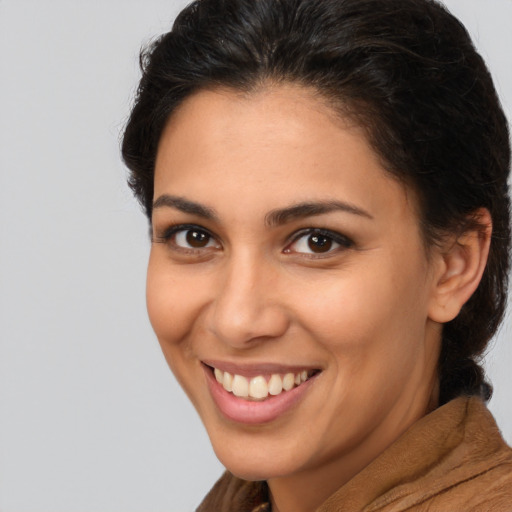 Joyful latino young-adult female with long  brown hair and brown eyes