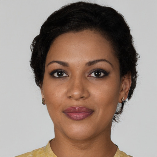 Joyful black young-adult female with short  black hair and brown eyes