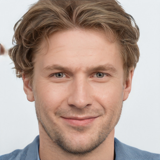 Joyful white young-adult male with short  brown hair and grey eyes