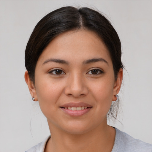 Joyful asian young-adult female with medium  brown hair and brown eyes