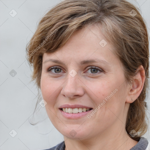 Joyful white young-adult female with medium  brown hair and blue eyes