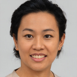 Joyful asian young-adult female with medium  black hair and brown eyes