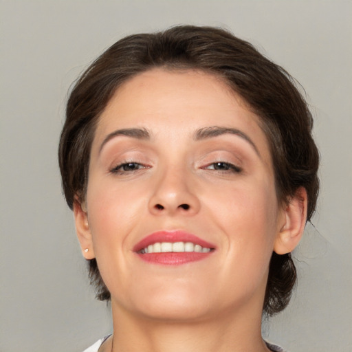 Joyful white young-adult female with medium  brown hair and brown eyes