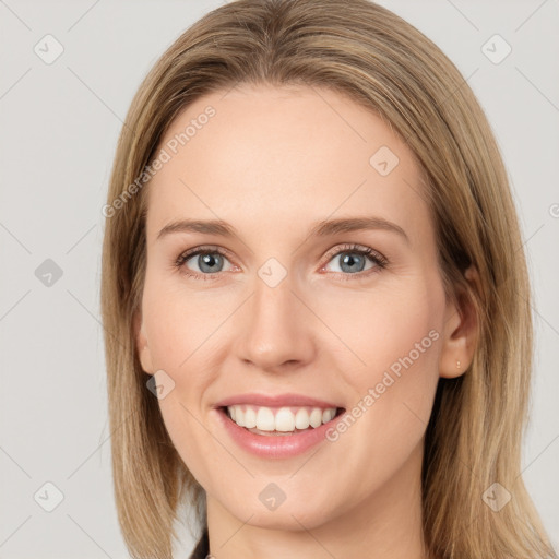 Joyful white young-adult female with medium  brown hair and grey eyes