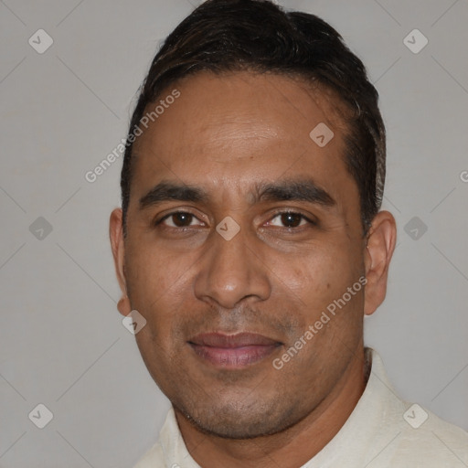 Joyful black adult male with short  brown hair and brown eyes