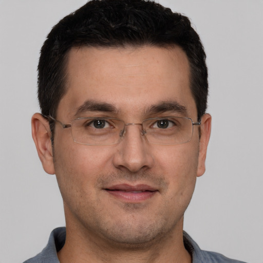 Joyful white adult male with short  brown hair and brown eyes