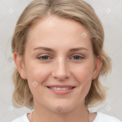 Joyful white young-adult female with medium  brown hair and blue eyes