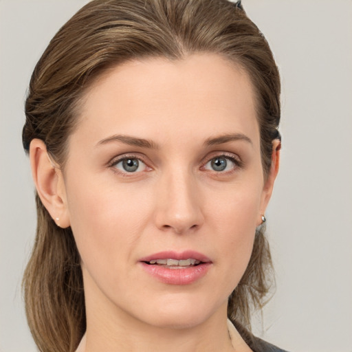 Joyful white young-adult female with medium  brown hair and grey eyes