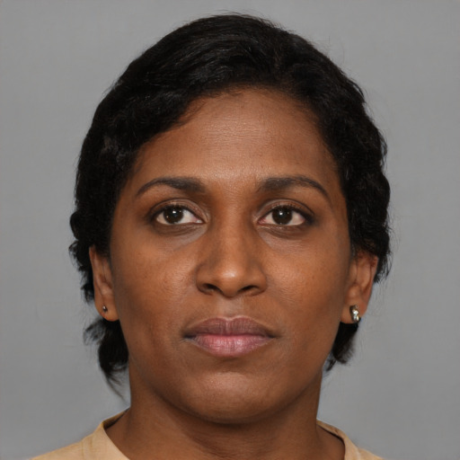 Neutral black young-adult female with medium  brown hair and brown eyes