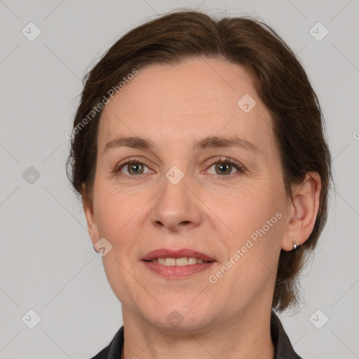 Joyful white adult female with medium  brown hair and grey eyes